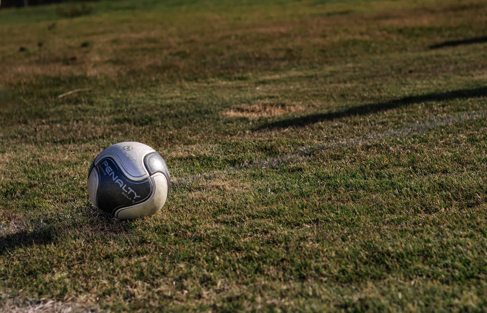 A football on a grassy playing field